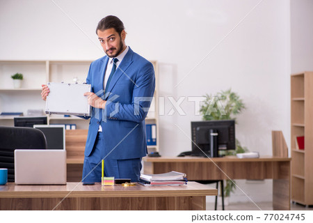 Young male employee in remuneration concept Young male employee in remuneration concept 77024745