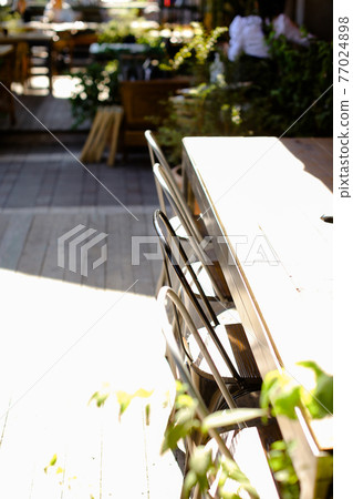 Details of interior of a small cafe, close up chairs and tables. Details of interior of a small cafe, close up chairs and tables. 77024898