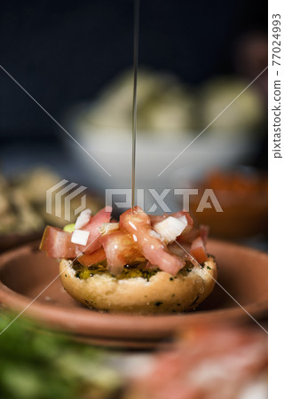 dressing an appetizer with olive oil dressing an appetizer with olive oil 77024993