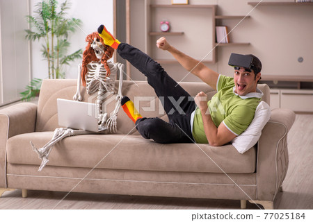Young man with female skeleton in virtual reality concept Young man with female skeleton in virtual reality concept 77025184