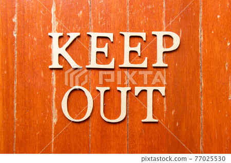 Alphabet letter in word keep out on old red color wood plate background Alphabet letter in word keep out on old red color wood plate background 77025530