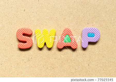 Foam alphabet letter in word swap on wood background 77025545