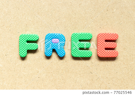 Foam alphabet letter in word free on wood background 77025546