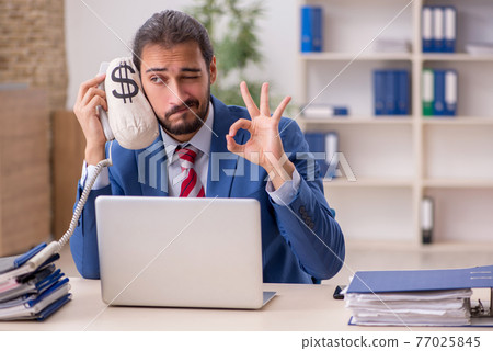 Young male employee in remuneration concept Young male employee in remuneration concept 77025845