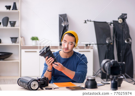 Young male photographer recording video for his blog Young male photographer recording video for his blog 77025974