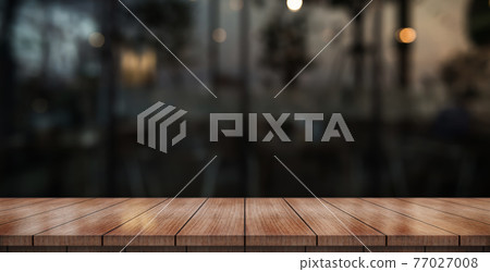 Empty wooden table top with lights bokeh on blur restaurant background. Empty wooden table top with lights bokeh on blur restaurant background. 77027008