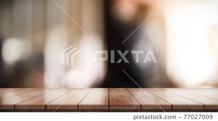 Empty wooden table top with lights bokeh on blur restaurant background. Empty wooden table top with lights bokeh on blur restaurant background. 77027009