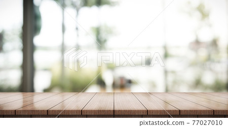 Empty wooden table top with lights bokeh on blur restaurant background. Empty wooden table top with lights bokeh on blur restaurant background. 77027010
