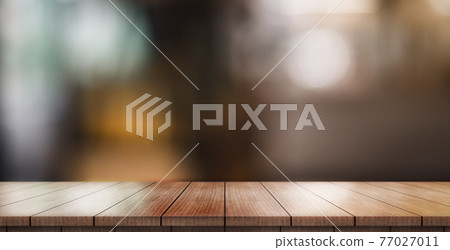 Empty wooden table top with lights bokeh on blur restaurant background. Empty wooden table top with lights bokeh on blur restaurant background. 77027011