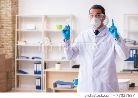 Young male doctor virologist in the office 77027687