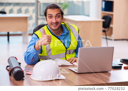 Young male architect working in the office 77028232