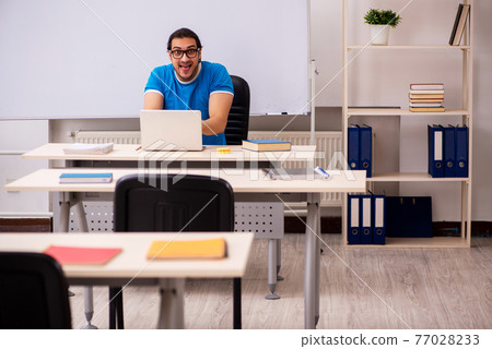 Young male student in the classroom Young male student in the classroom 77028233