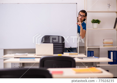 Young male student in the classroom Young male student in the classroom 77028235