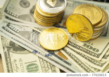 Ethereum coins and bitcoin on a dollars and on a laptop. Trading on the cryptocurrency exchange. Cryptocurrency Stock Market Concept. Mining or blockchain technology. Business concept. Ethereum coins and bitcoin on a dollars and on a laptop. Trading on the cryptocurrency exchange. Cryptocurrency Stock Market Concept. Mining or blockchain technology. Business concept. 77028813