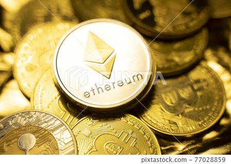 Gold ethereum coins on a golden background among another crypto coins. Trading on cryptocurrency exchange. Cryptocurrency Stock Market Concept. Virtual money concept. Mining blockchain technology. Gold ethereum coins on a golden background among another crypto coins. Trading on cryptocurrency exchange. Cryptocurrency Stock Market Concept. Virtual money concept. Mining blockchain technology. 77028859