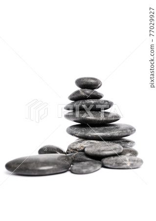 Black pebbles stacked on top of each other Black pebbles stacked on top of each other 77029927