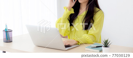 Young asian business woman working form home office and call phone for success at home. 77030129