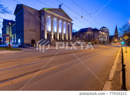 Poznan. Facade of the building of the opera house at sunrise. 77030221