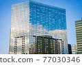 Clouds and blue sky reflected in the building 77030346