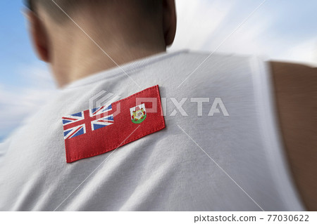 The national flag of Bermuda on the athlete's back 77030622