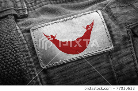 Tag on dark clothing in the form of the flag of the Easter Island Tag on dark clothing in the form of the flag of the Easter Island 77030638