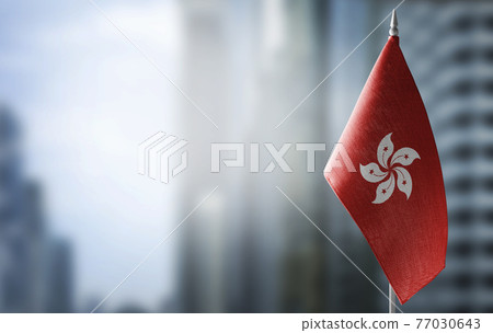 A small flag of Hong Kong on the background of a blurred background A small flag of Hong Kong on the background of a blurred background 77030643