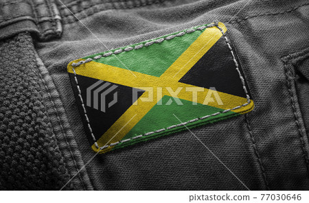 Tag on dark clothing in the form of the flag of the Jamaica Tag on dark clothing in the form of the flag of the Jamaica 77030646