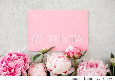 Mockup invitation, blank paper greeting card and peonies on gray stone table. Flower background. Flat lay, top view. Mockup invitation, blank paper greeting card and peonies on gray stone table. Flower background. Flat lay, top view. 77030766