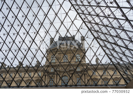 View of Louvre Museum from inside the glass Pyramid in Paris, France. View of Louvre Museum from inside the glass Pyramid in Paris, France. 77030932