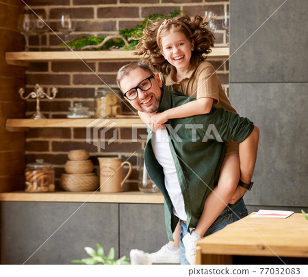 Young joyful father and daughter playing together at home Young joyful father and daughter playing together at home 77032083