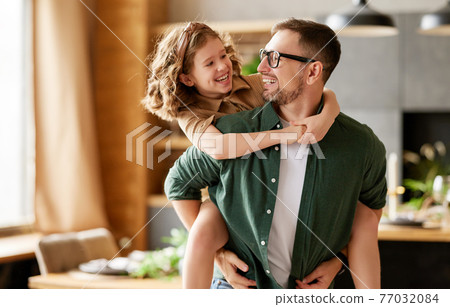Young joyful father and daughter playing together at home Young joyful father and daughter playing together at home 77032084