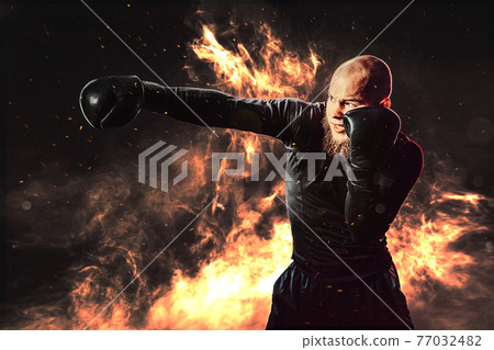 Sportsman boxer training, hitting direct hit on background with 77032482