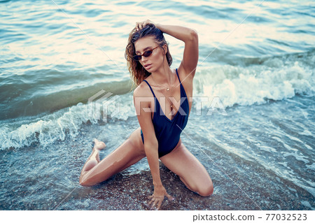 portrait of beautiful sexy Caucasian sunbathed woman in sunglass portrait of beautiful sexy Caucasian sunbathed woman in sunglass 77032523