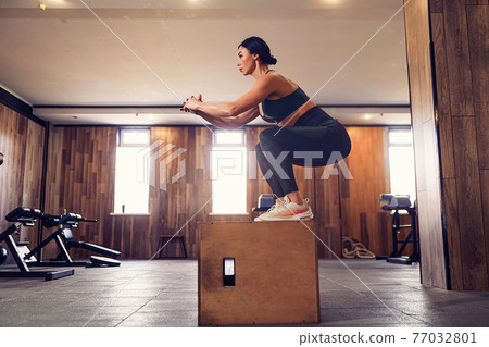Shot of young woman working out with a box at the gym. Female at Shot of young woman working out with a box at the gym. Female at 77032801
