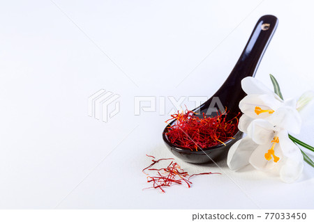 Saffron threads and white crocus flowers. Saffron threads and white crocus flowers. 77033450