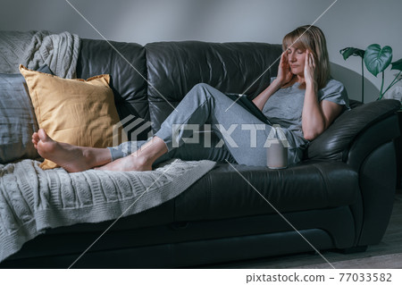 Woman with a headache Woman with a headache 77033582
