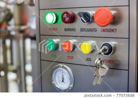 Machine control panel with push buttons and switches at factory Machine control panel with push buttons and switches at factory 77033686