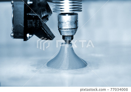 Modern 3D printer printing figure blue colors close-up 77034008