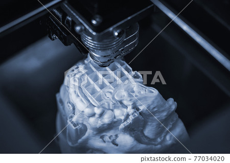 3D printer prints the form of molten plastic white. 3D printer prints the form of molten plastic white. 77034020