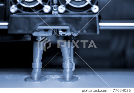 3D printer prints the form of molten plastic green. 3D printer prints the form of molten plastic green. 77034026