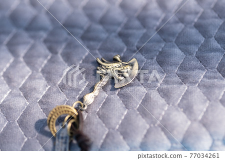 Vintage gothic pendant ax necklace bronze color closeup. Selective Focus 77034261