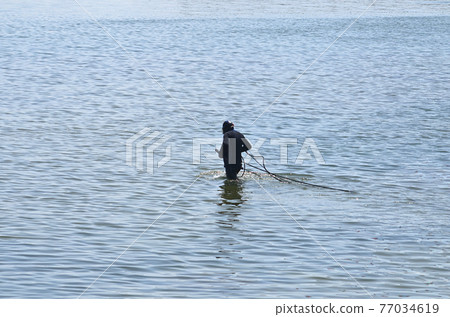 Worker conducting repair work in marine 77034619
