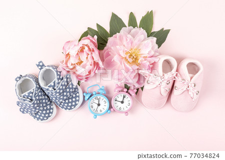 Girl and boy shoes with pink and blue watches on pink Girl and boy shoes with pink and blue watches on pink 77034824