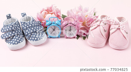 Girl and boy shoes with pink and blue watches on pink Girl and boy shoes with pink and blue watches on pink 77034825