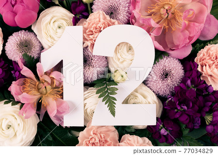 Layout with colorful flowers, leaves and number twelve. Layout with colorful flowers, leaves and number twelve. 77034829