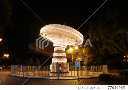 Rotating carousel on the boulevard in Baku. Azerbaijan Rotating carousel on the boulevard in Baku. Azerbaijan 77034965