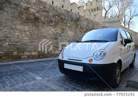 White subcompact car on the street of Baku 77035291