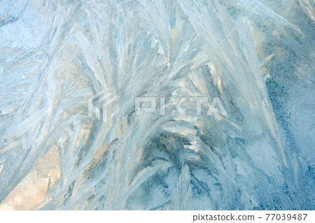 frosty patterns on the window glass. natural textures and backgrounds. ice patterns on frozen frosty patterns on the window glass. natural textures and backgrounds. ice patterns on frozen 77039487