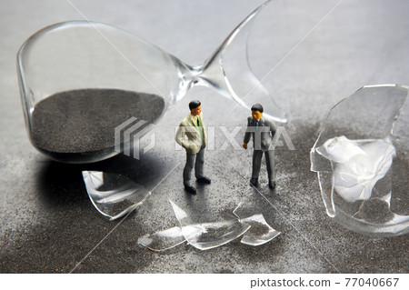 miniature people. figures people stand near the broken hourglass. business crisis. stop time process miniature people. figures people stand near the broken hourglass. business crisis. stop time process 77040667