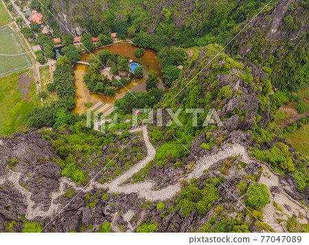 Top pagoda of Hang Mua temple, rice fields, Ninh Binh, Vietnam. Vietnam reopens borders after quarantine Coronovirus COVID 19 Top pagoda of Hang Mua temple, rice fields, Ninh Binh, Vietnam. Vietnam reopens borders after quarantine Coronovirus COVID 19 77047089